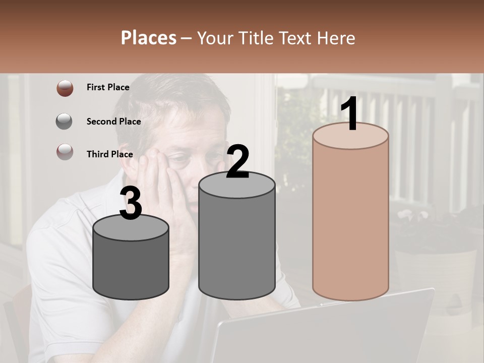 A Man Sitting At A Table With A Laptop In Front Of Him PowerPoint Template