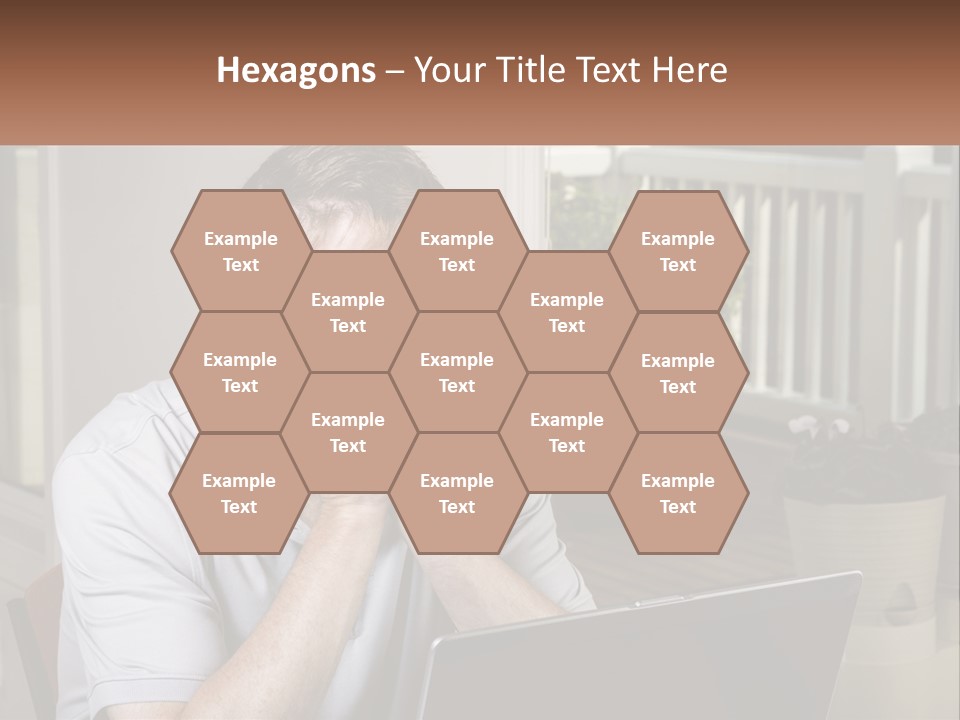 A Man Sitting At A Table With A Laptop In Front Of Him PowerPoint Template