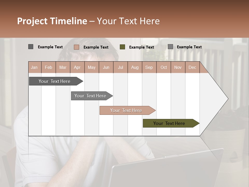 A Man Sitting At A Table With A Laptop In Front Of Him PowerPoint Template