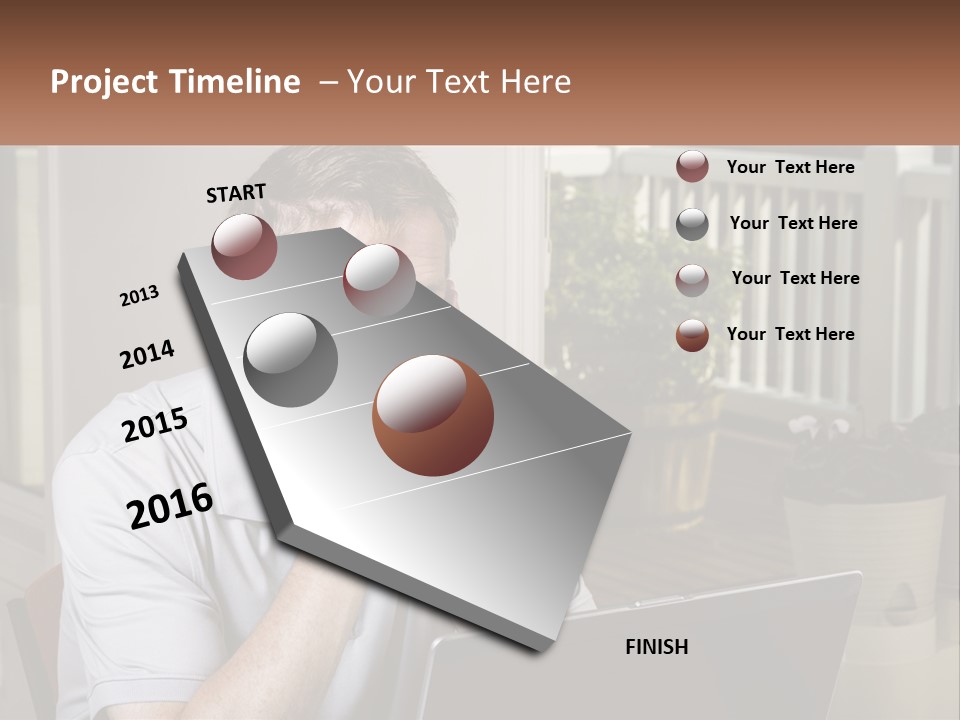A Man Sitting At A Table With A Laptop In Front Of Him PowerPoint Template