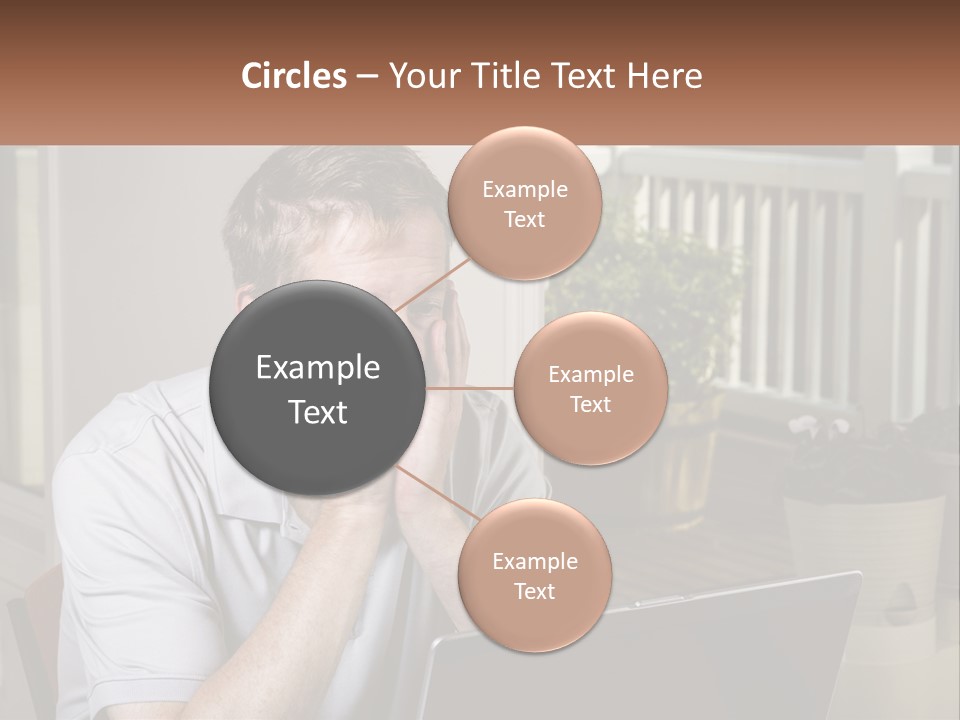 A Man Sitting At A Table With A Laptop In Front Of Him PowerPoint Template
