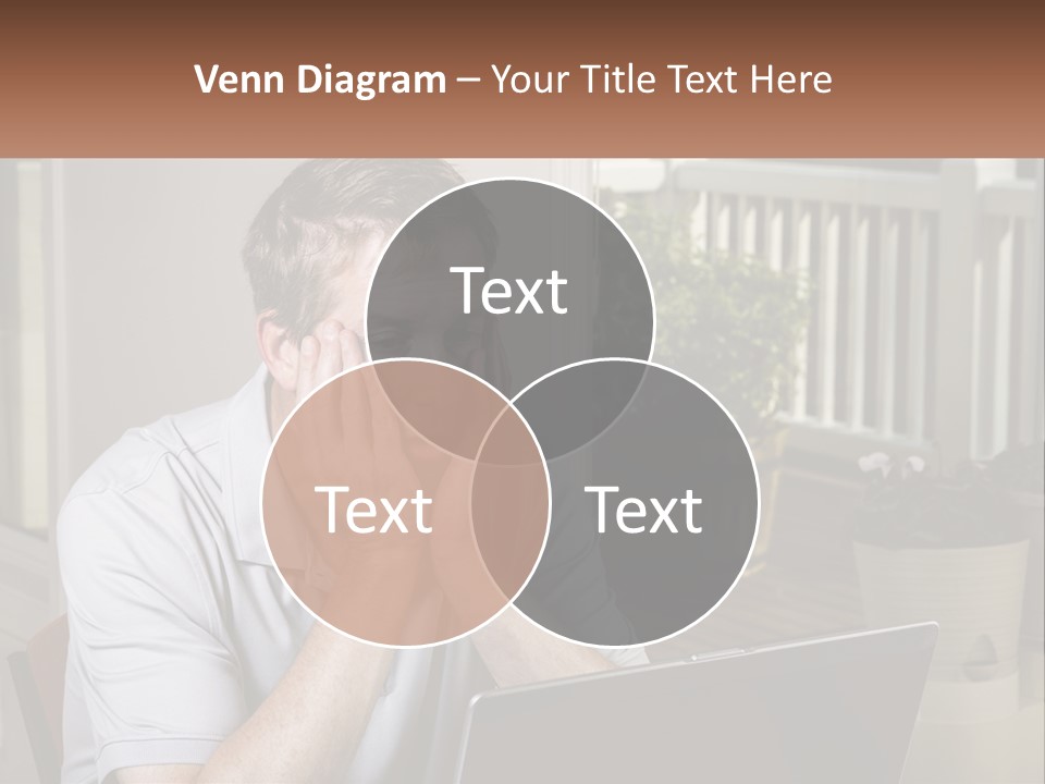 A Man Sitting At A Table With A Laptop In Front Of Him PowerPoint Template