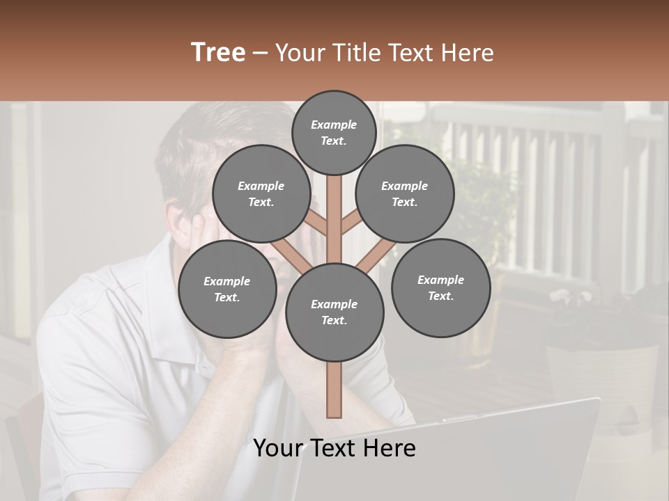 A Man Sitting At A Table With A Laptop In Front Of Him PowerPoint Template