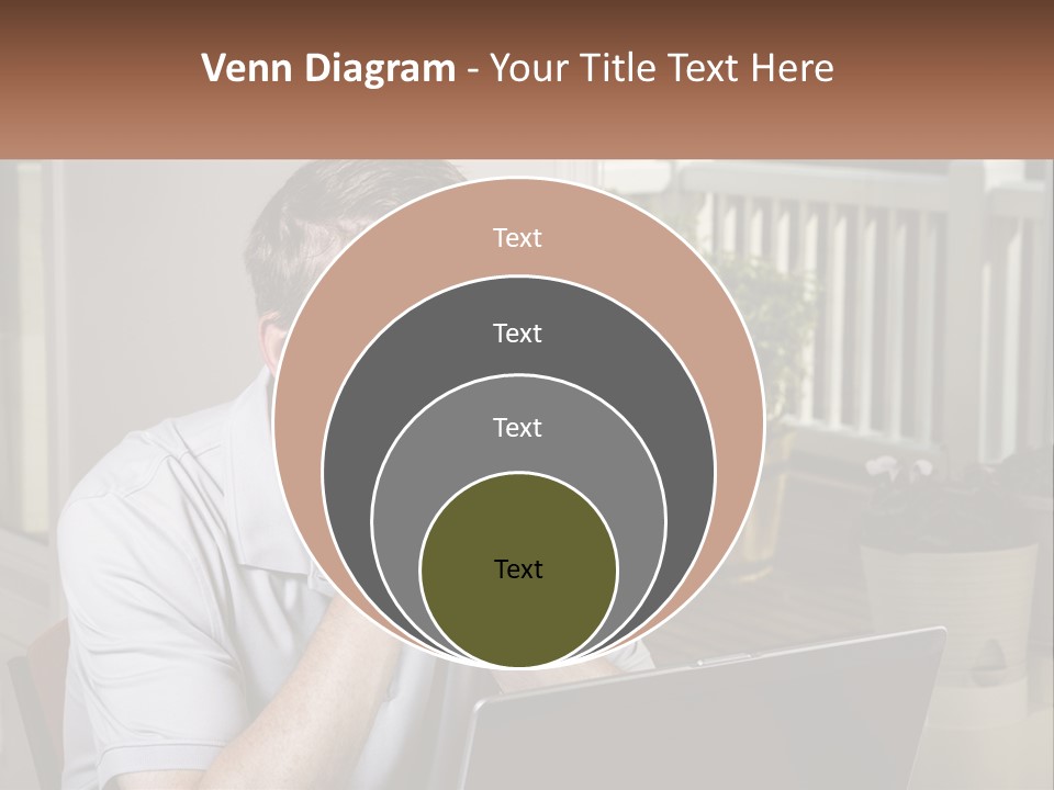 A Man Sitting At A Table With A Laptop In Front Of Him PowerPoint Template
