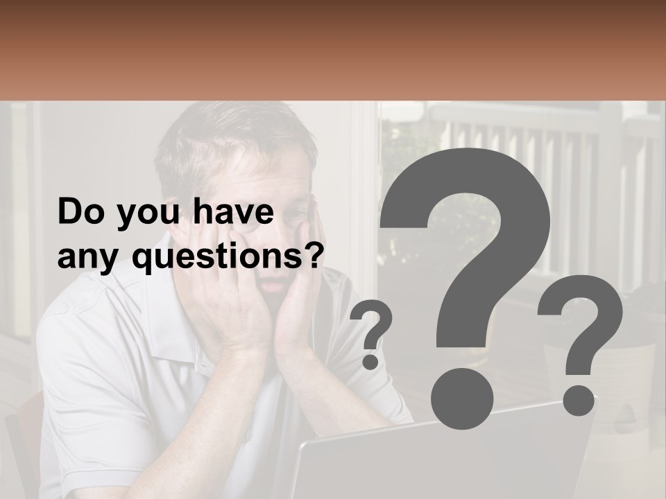 A Man Sitting At A Table With A Laptop In Front Of Him PowerPoint Template