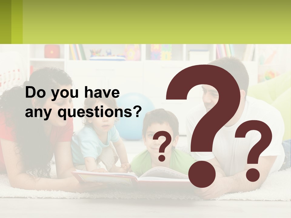 A Family Laying On The Floor With A Book PowerPoint Template