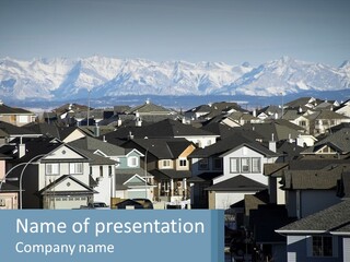 A Large Group Of Houses With Mountains In The Background PowerPoint Template