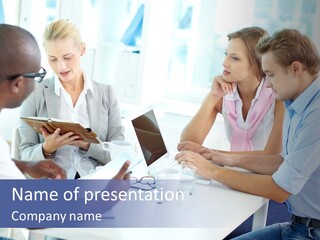 A Group Of People Sitting Around A Table With A Laptop PowerPoint Template