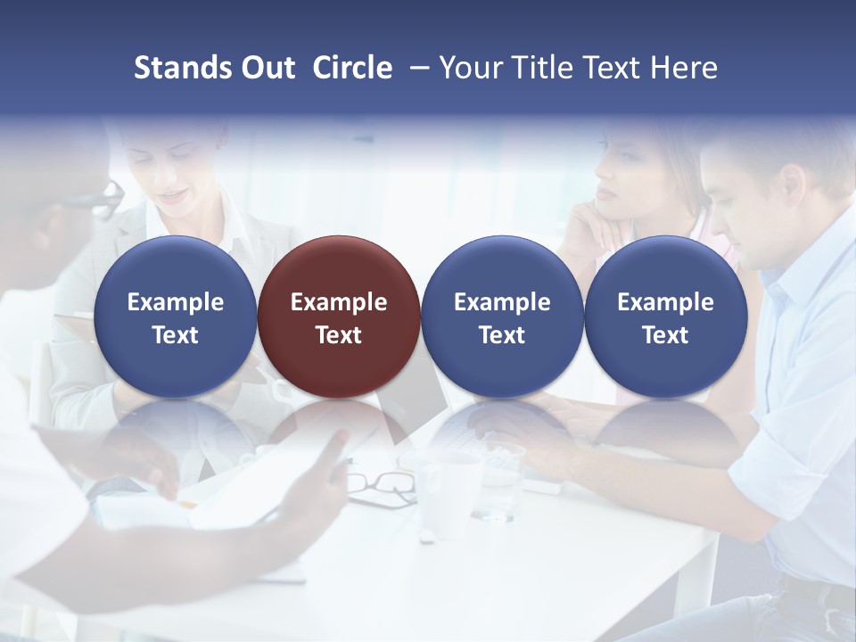 A Group Of People Sitting Around A Table With A Laptop PowerPoint Template