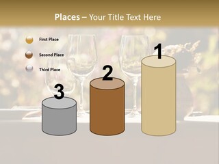 A Table Topped With Two Wine Glasses And A Vase Filled With Flowers PowerPoint Template
