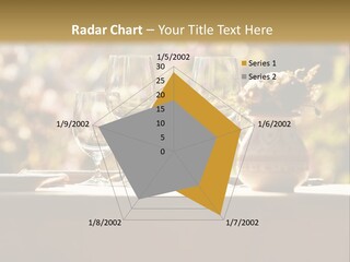 A Table Topped With Two Wine Glasses And A Vase Filled With Flowers PowerPoint Template