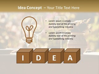 A Table Topped With Two Wine Glasses And A Vase Filled With Flowers PowerPoint Template