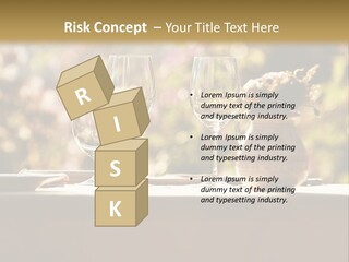 A Table Topped With Two Wine Glasses And A Vase Filled With Flowers PowerPoint Template