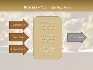 A Table Topped With Two Wine Glasses And A Vase Filled With Flowers PowerPoint Template