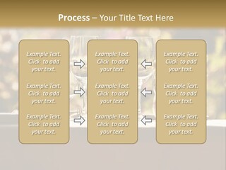 A Table Topped With Two Wine Glasses And A Vase Filled With Flowers PowerPoint Template