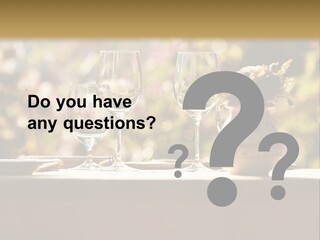 A Table Topped With Two Wine Glasses And A Vase Filled With Flowers PowerPoint Template