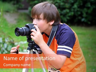 A Young Boy Taking A Picture With A Camera PowerPoint Template