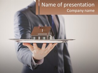 A Man Holding A Plate With A House On It PowerPoint Template