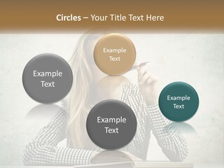 A Woman Sitting At A Table With A Pen In Her Mouth PowerPoint Template