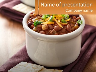 A White Bowl Filled With Chili And Cheese PowerPoint Template