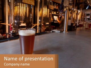 A Glass Of Beer Sitting On A Bar PowerPoint Template