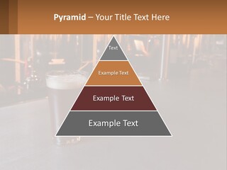 A Glass Of Beer Sitting On A Bar PowerPoint Template