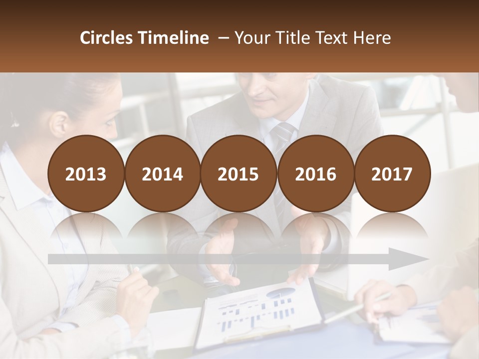 A Group Of People Sitting Around A Table Talking PowerPoint Template