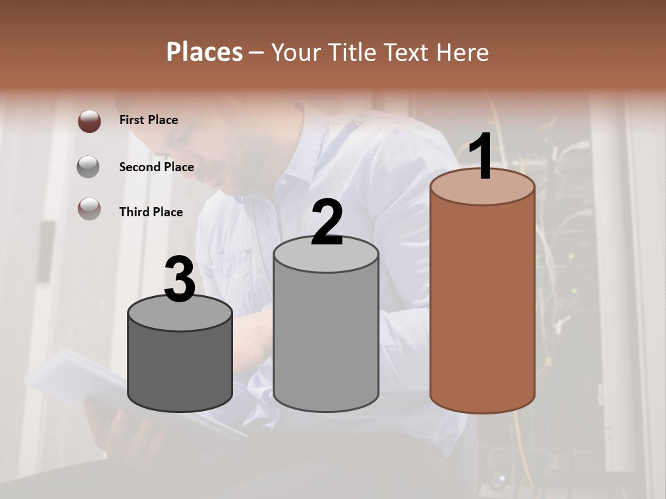 A Man Sitting In Front Of A Server In A Server Room PowerPoint Template