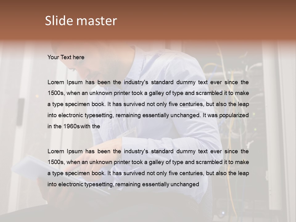 A Man Sitting In Front Of A Server In A Server Room PowerPoint Template