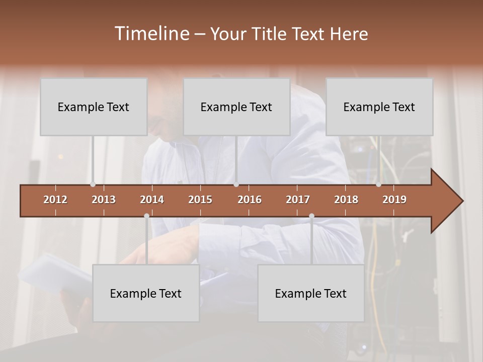 A Man Sitting In Front Of A Server In A Server Room PowerPoint Template