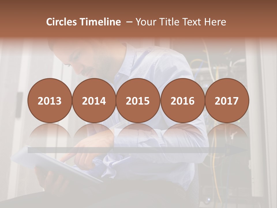 A Man Sitting In Front Of A Server In A Server Room PowerPoint Template