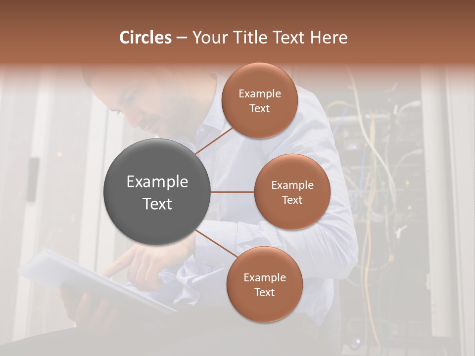 A Man Sitting In Front Of A Server In A Server Room PowerPoint Template