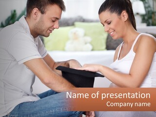 A Man And Woman Sitting On A Couch Looking At A Hat PowerPoint Template