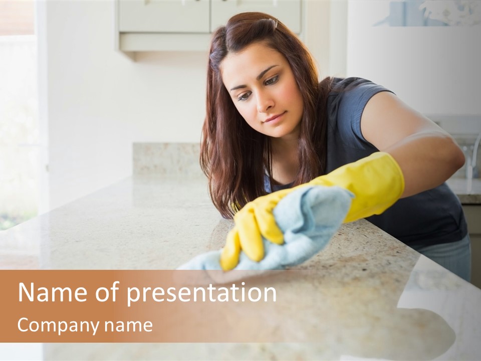 A Woman Cleaning A Kitchen Counter With Yellow Gloves PowerPoint Template