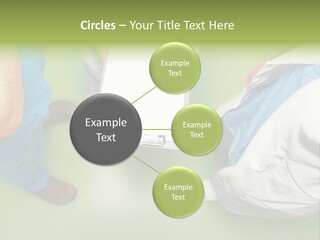 A Group Of People Standing Around A Binder PowerPoint Template