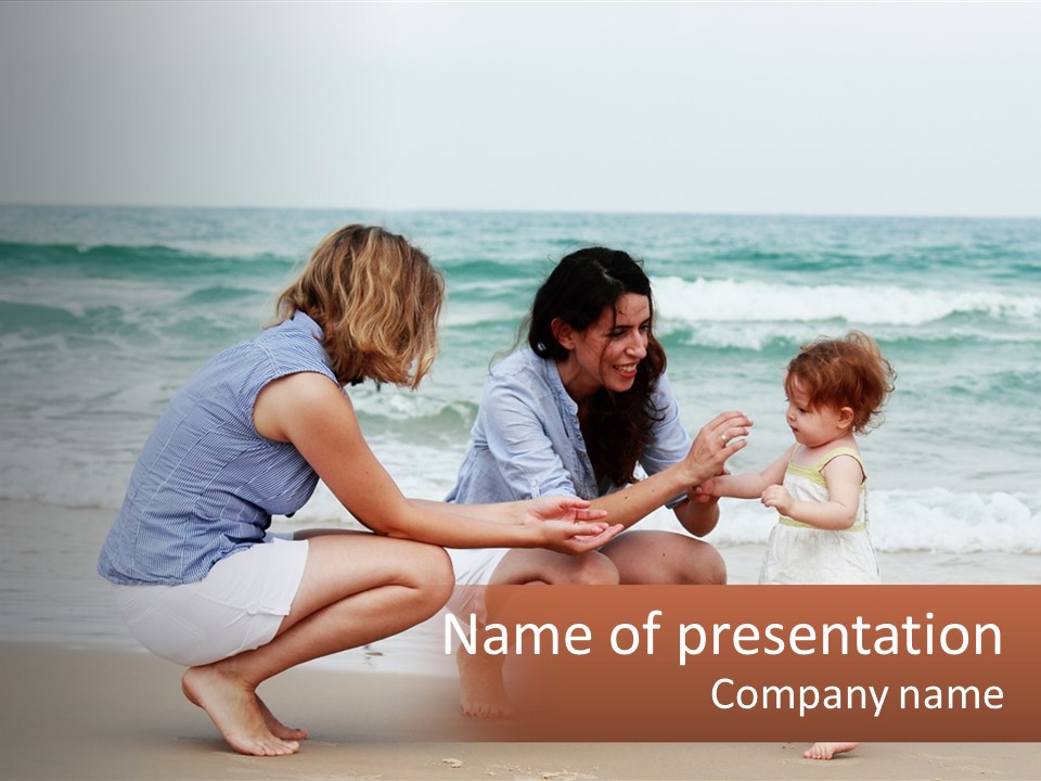 A Woman And Two Children Playing On The Beach PowerPoint Template