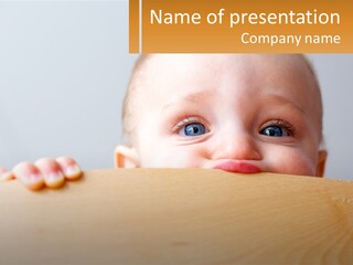 A Baby Is Peeking Over A Wooden Table PowerPoint Template