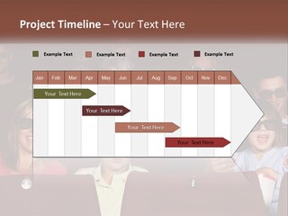 A Group Of People Sitting In A Movie Theater PowerPoint Template