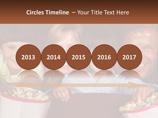 A Family Is Watching A Movie In A Theater PowerPoint Template