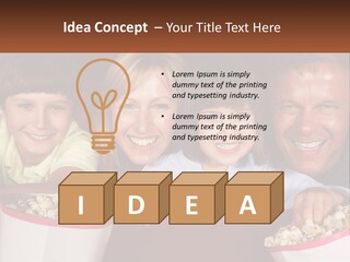 A Family Is Watching A Movie In A Theater PowerPoint Template