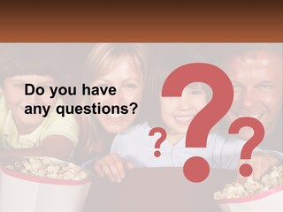 A Family Is Watching A Movie In A Theater PowerPoint Template