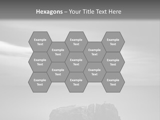 A Black And White Photo Of A Rock In The Ocean PowerPoint Template