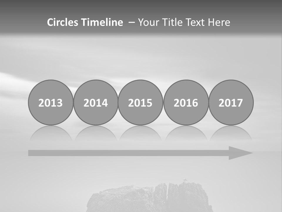 A Black And White Photo Of A Rock In The Ocean PowerPoint Template