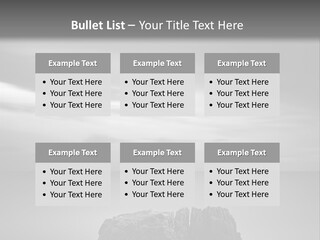 A Black And White Photo Of A Rock In The Ocean PowerPoint Template