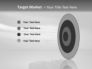 A Black And White Photo Of A Rock In The Ocean PowerPoint Template
