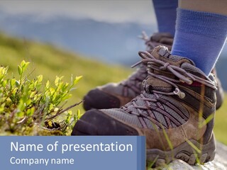 A Person In Hiking Boots Standing On A Rock PowerPoint Template