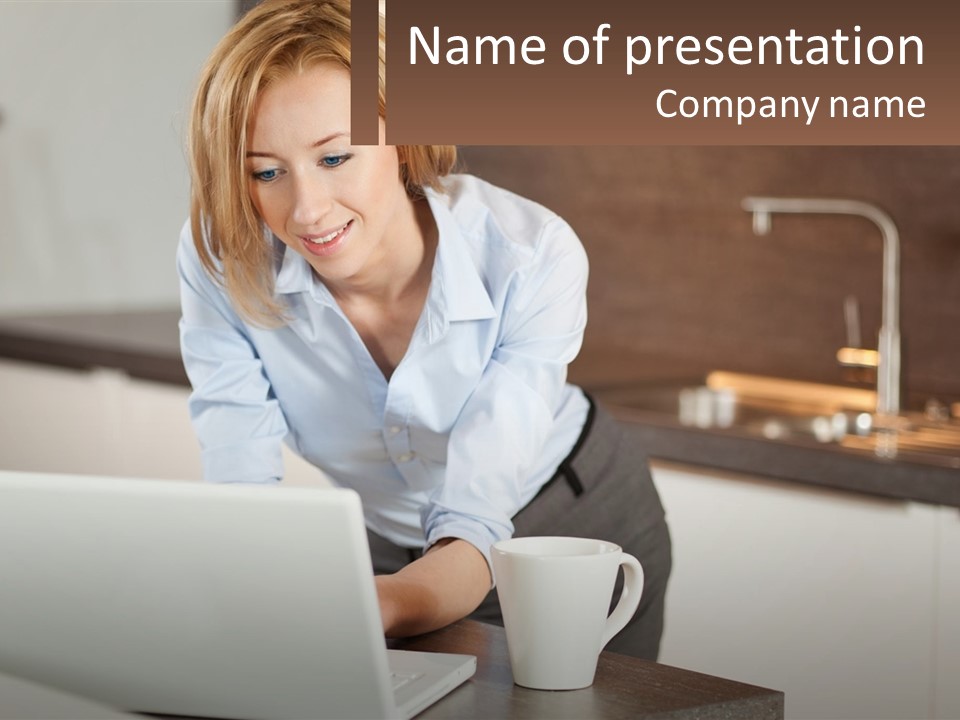 A Woman Sitting At A Table Using A Laptop Computer PowerPoint Template