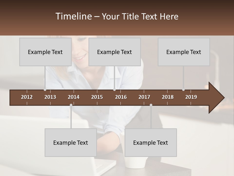 A Woman Sitting At A Table Using A Laptop Computer PowerPoint Template