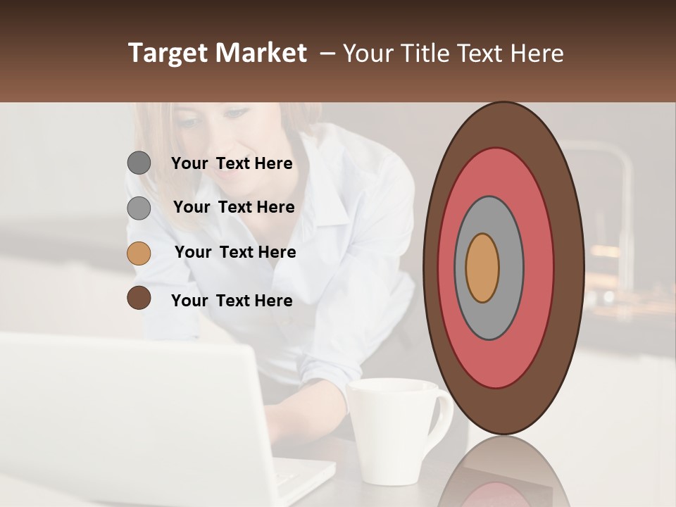 A Woman Sitting At A Table Using A Laptop Computer PowerPoint Template