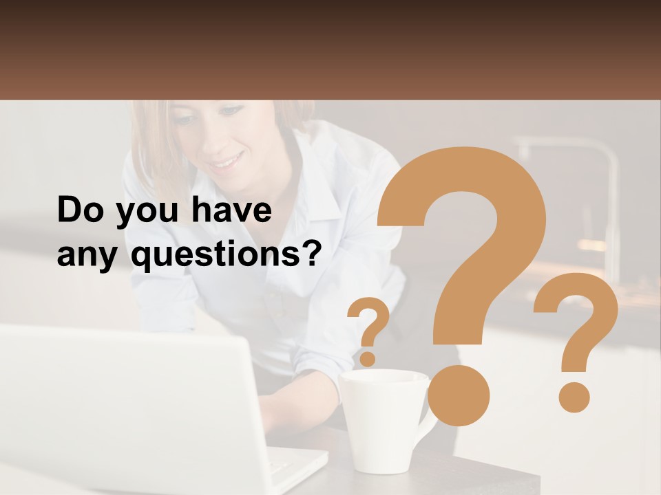 A Woman Sitting At A Table Using A Laptop Computer PowerPoint Template